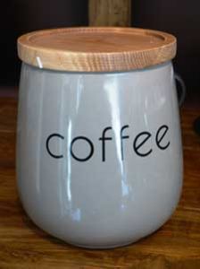 White ceramic canister labelled coffee has wooden lid
